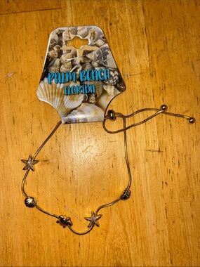 Gold tone beach themed charm adjustable bracelet. NWT.